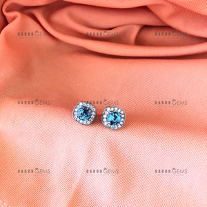 Individually Hand-crafted Pair of Silver Swiss Blue Topaz Gemstone Studs surrounded by Cubic Zirconia &amp; Rhodium.